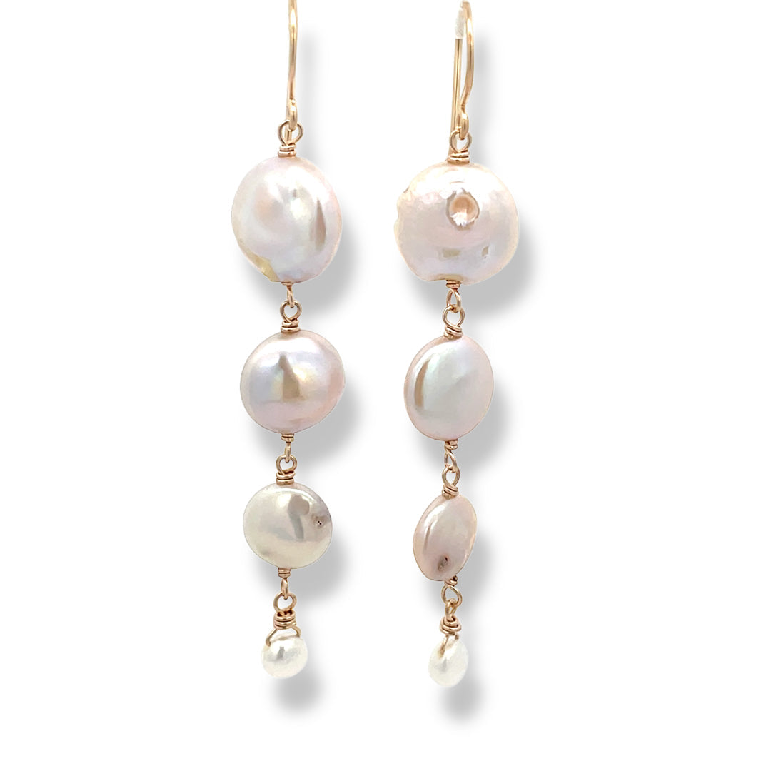 Pearl earrings with gold hooks on a white background