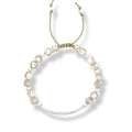 Neutral agate bracelet with sterling silver curved bar and beige cord, featuring soft white-accented gemstones