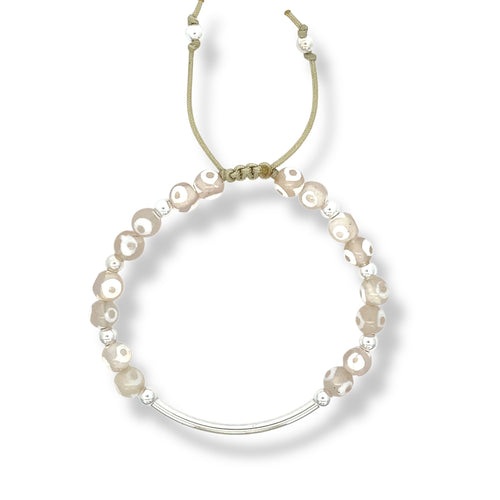 Neutral agate bracelet with sterling silver curved bar and beige cord, featuring soft white-accented gemstones