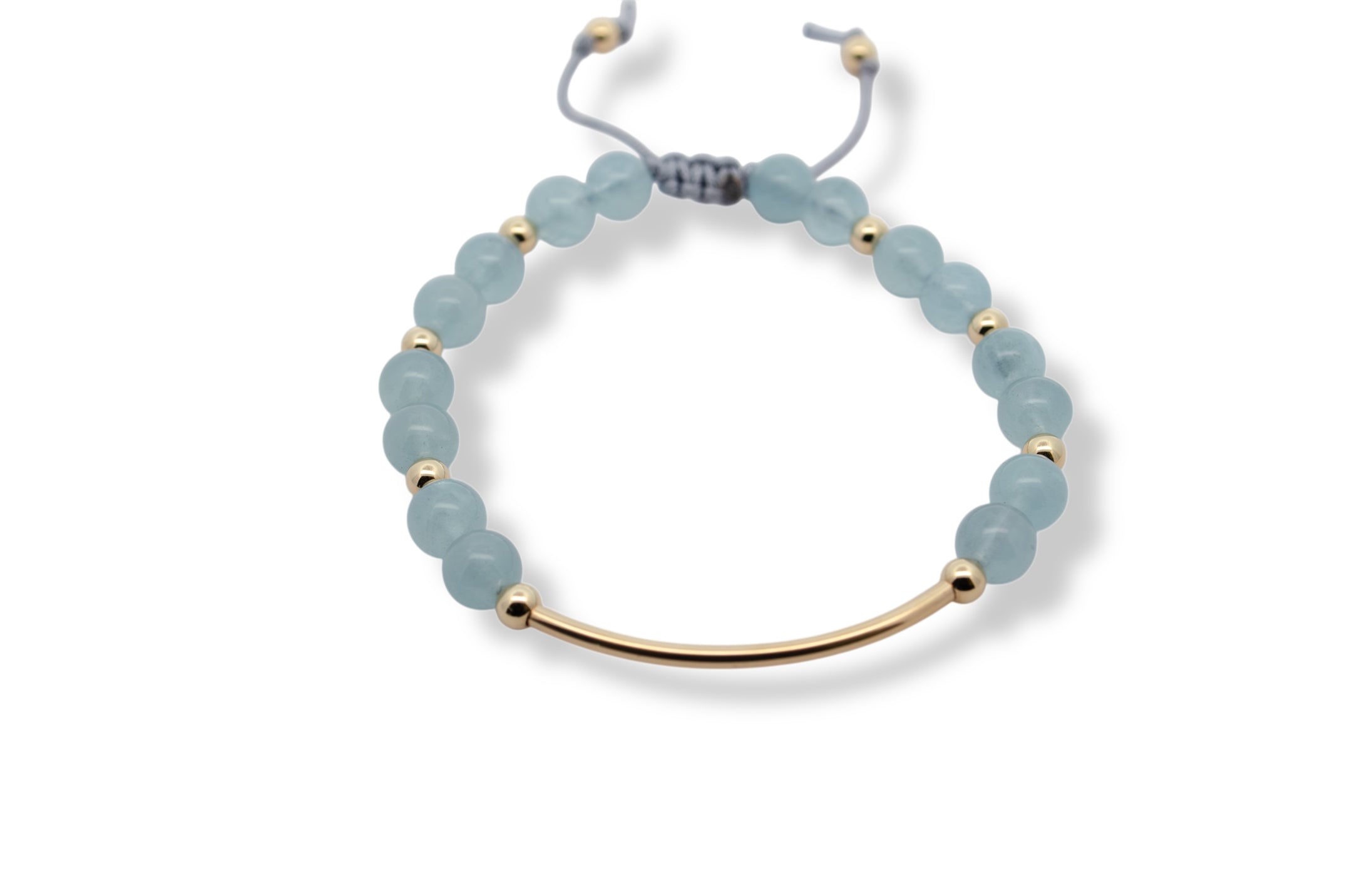 Bracelet with light blue beads and gold accents on a white background