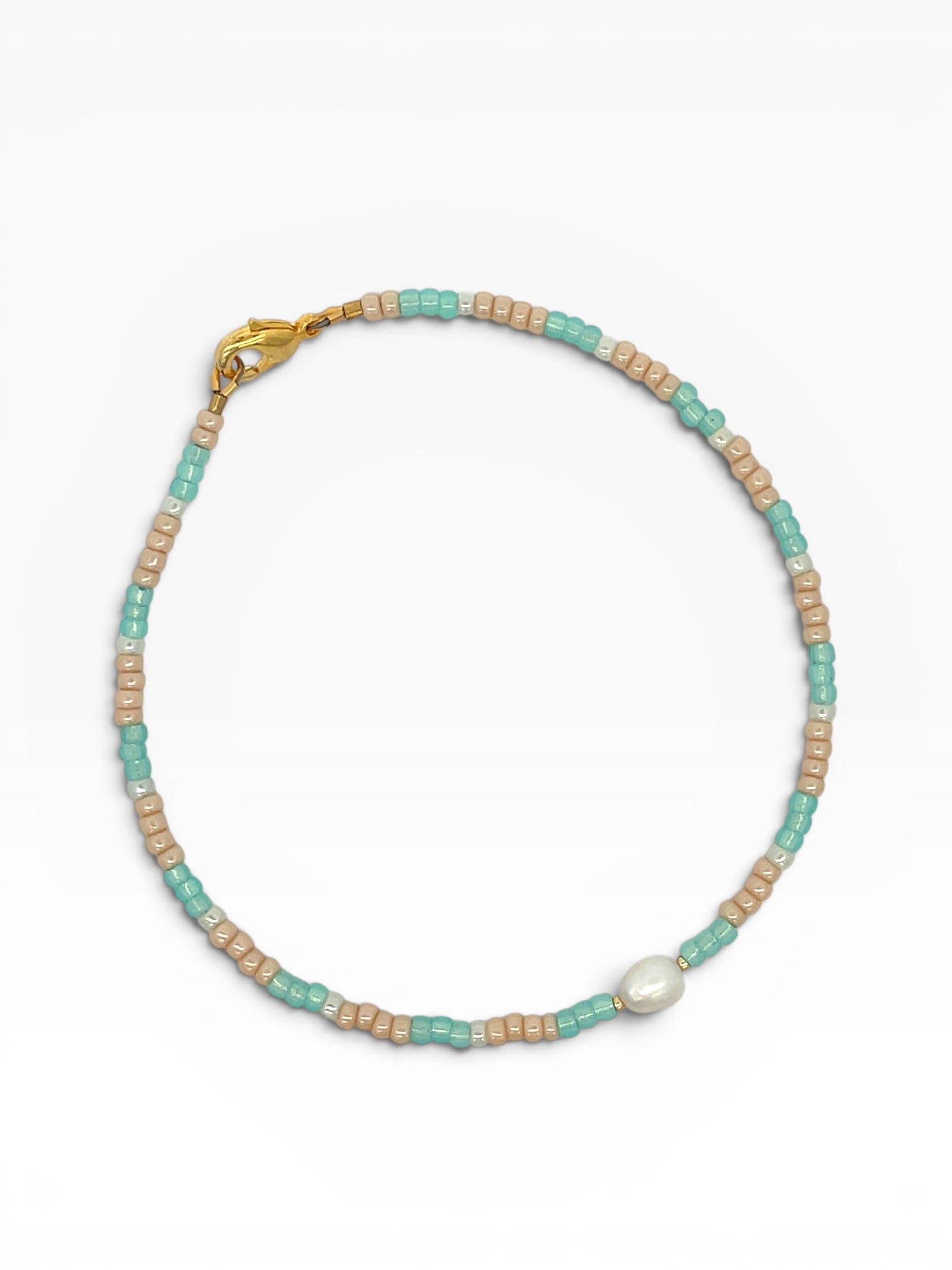 Anklet  with turquoise and beige beads on a white background