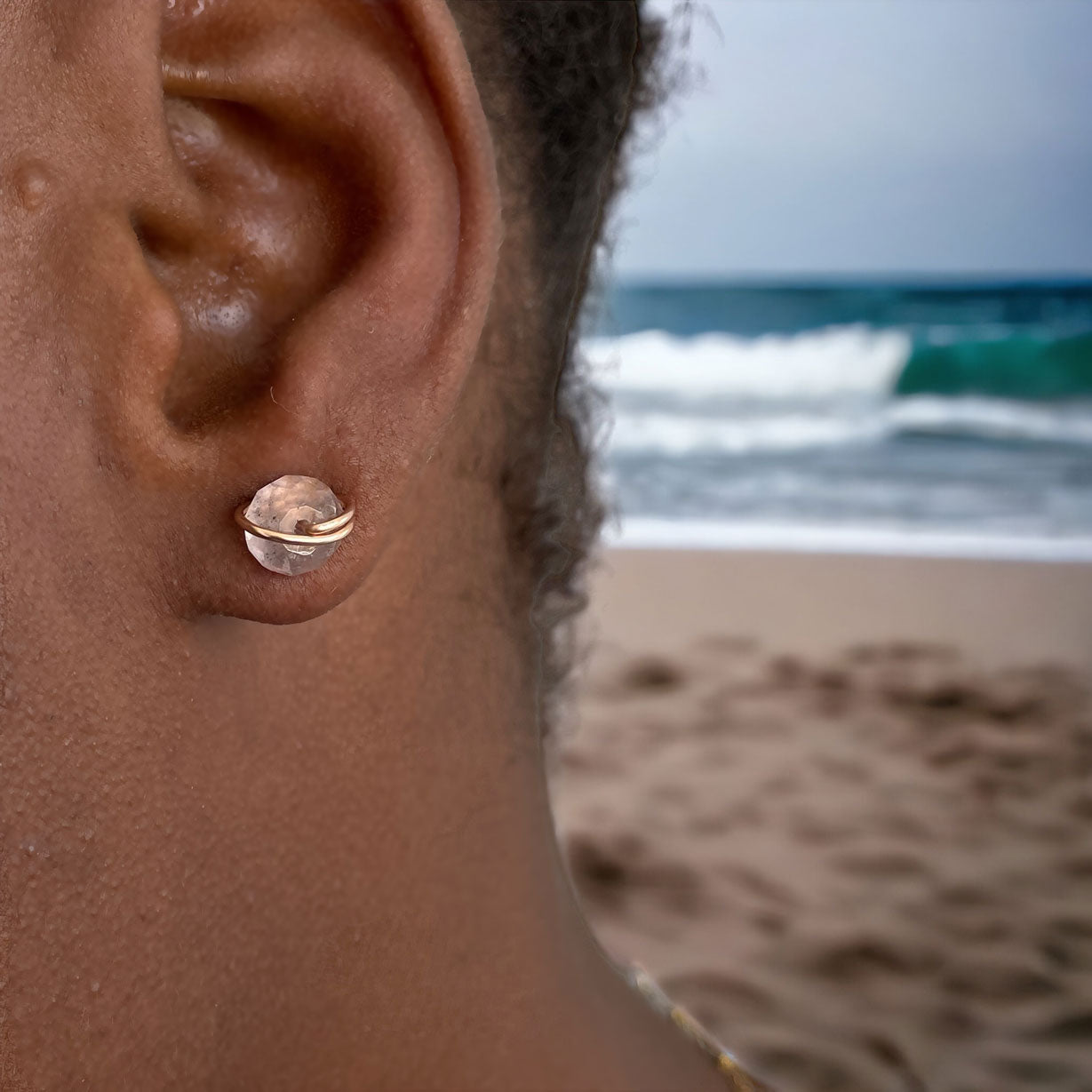Model wearing quartz studs earrings in rose gold