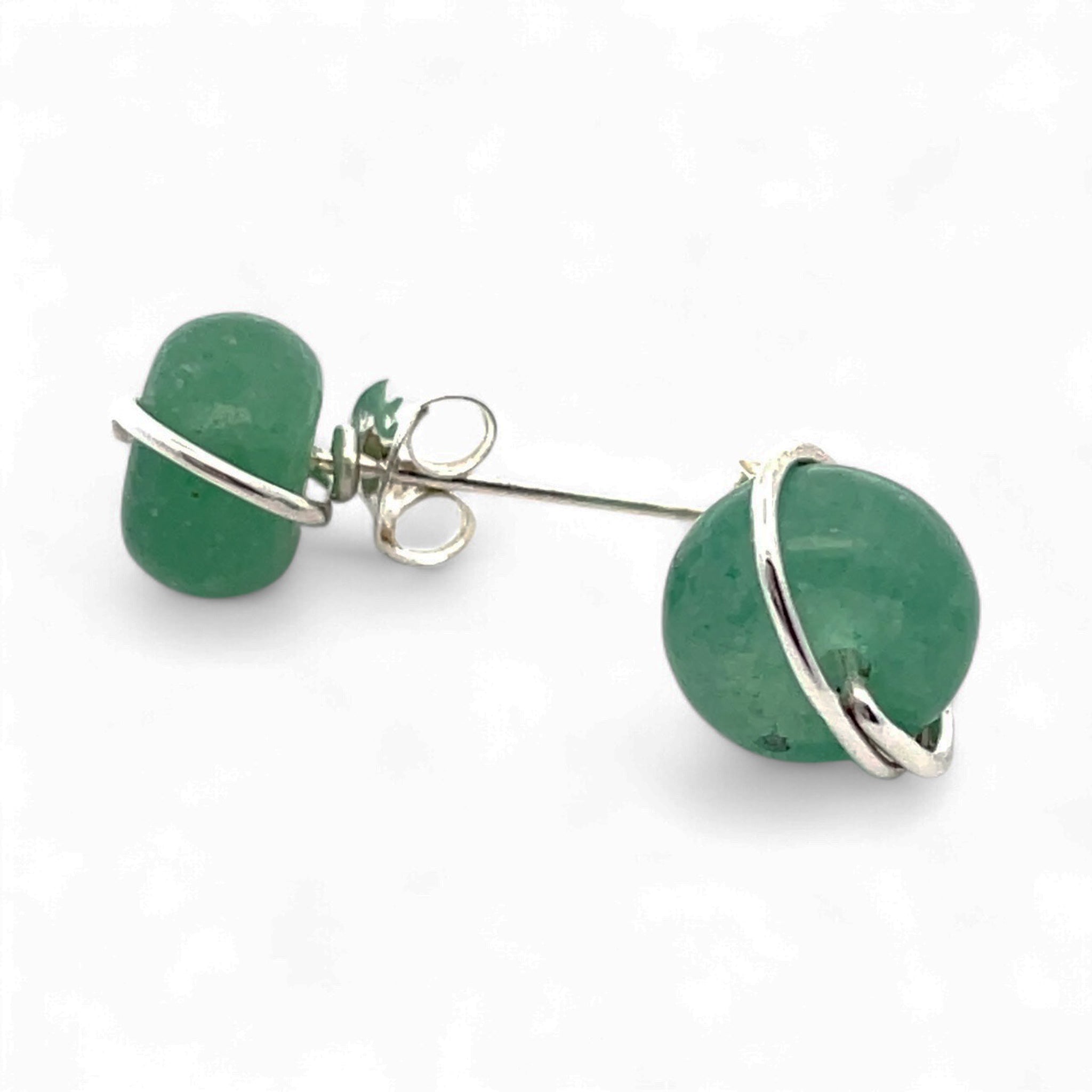 Green earrings with silver loops on a white background