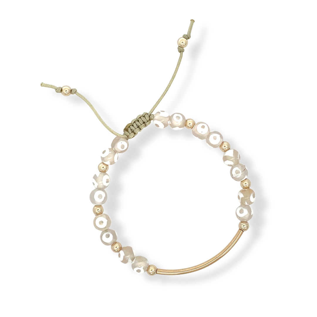 Neutral agate bracelet with 14K gold-filled curved bar and beige cord, hand-strung with natural white-accented gemstones