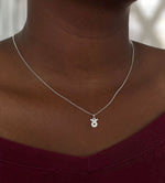 Load image into Gallery viewer, Model wearing a Taurus necklace styled solo, showing length and natural fall at 16”

