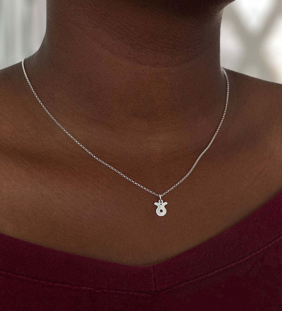 Model wearing a Taurus necklace styled solo, showing length and natural fall at 16”