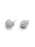 A pair of silver wrap-around stud earrings with smooth, oval, pale blue-gray cabochon stones, shown on a clean white background.