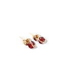 Load image into Gallery viewer, Gold earrings with red gemstones on a white background
