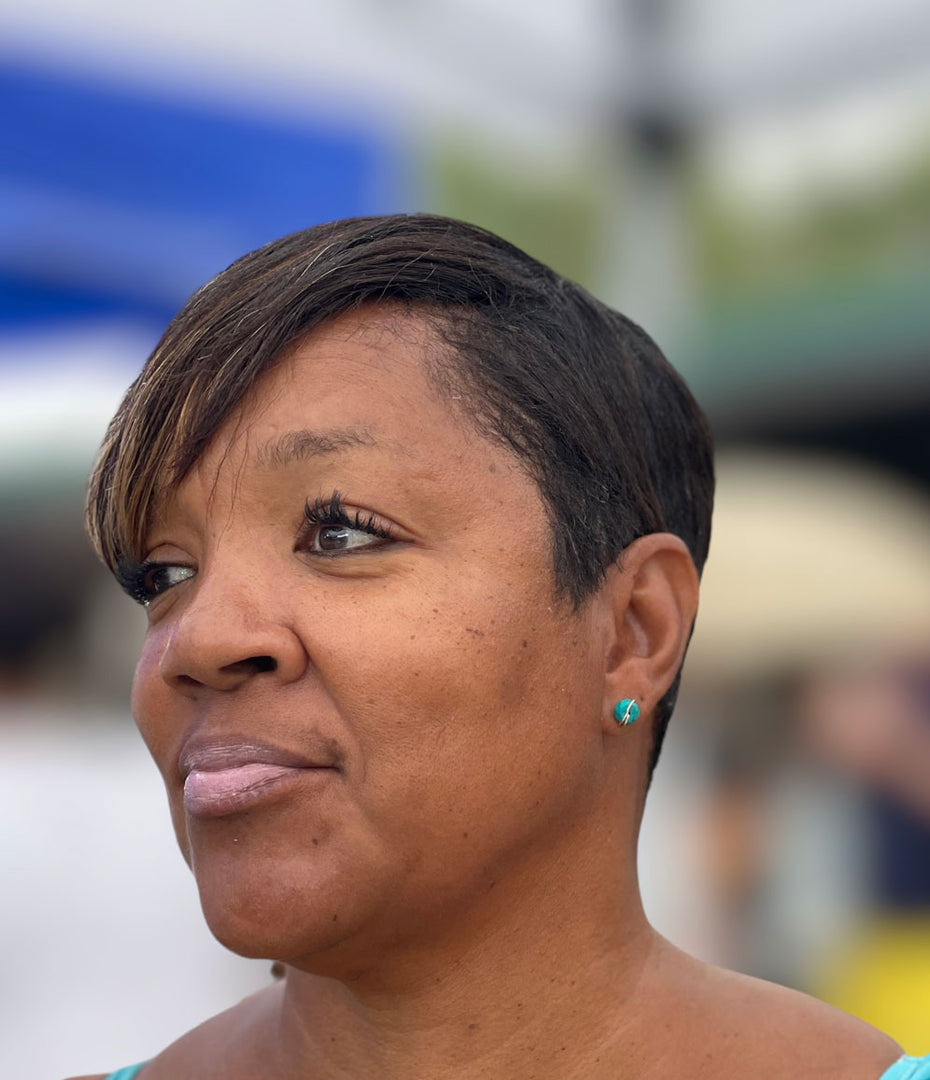 lady wearing turquoise stud earring 